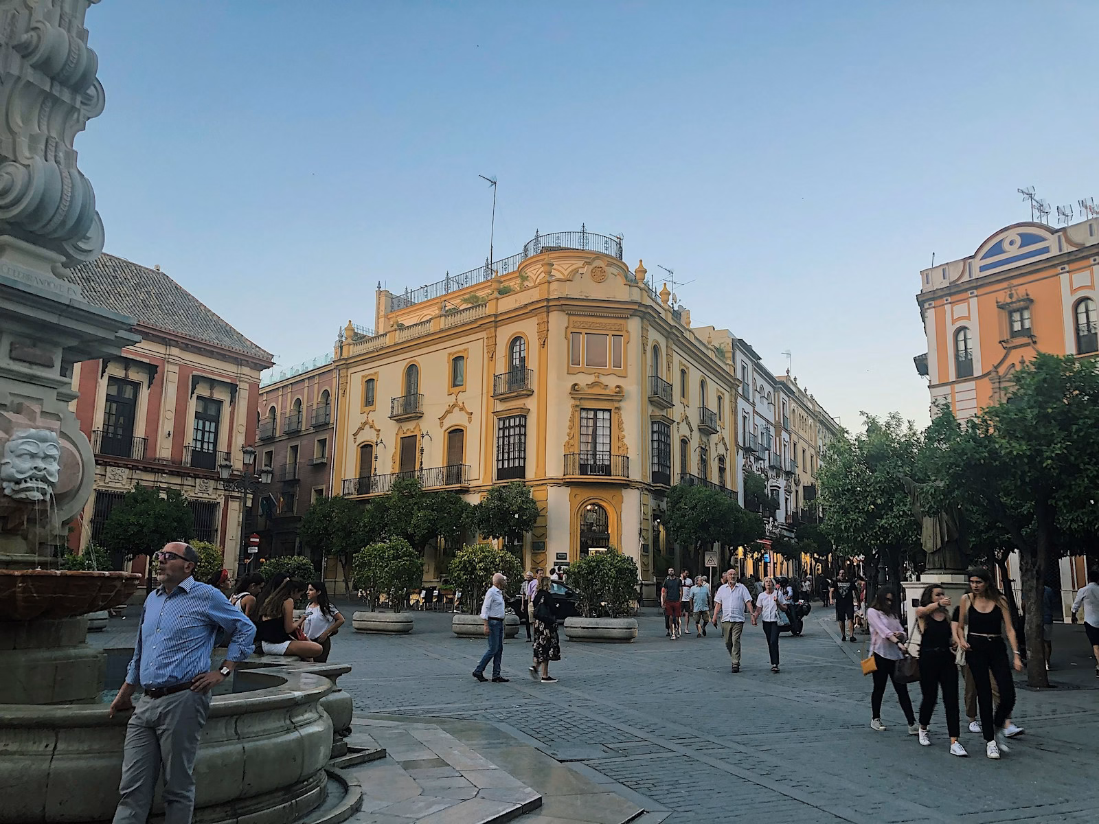 group of people walking near beige structure