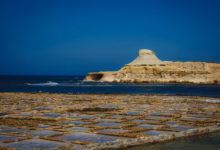 white rock formation on sea under blue sky during daytime