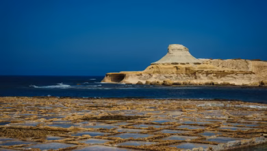 white rock formation on sea under blue sky during daytime