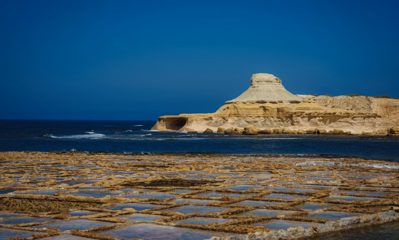 white rock formation on sea under blue sky during daytime