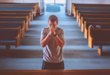 man standing near altar praying