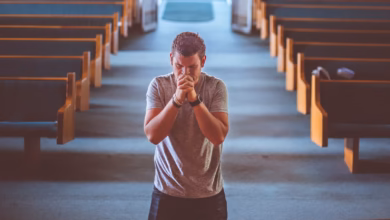 man standing near altar praying