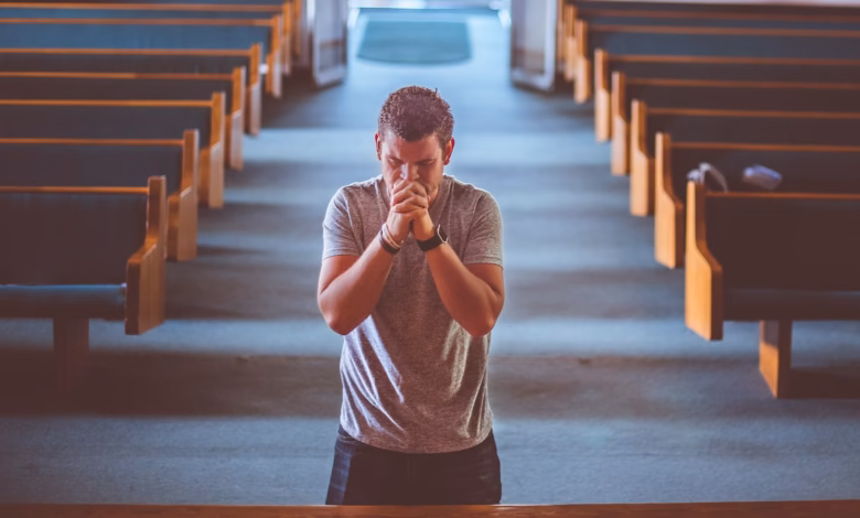 man standing near altar praying