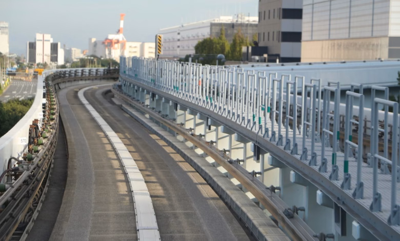 Elevated train tracks curve through a modern cityscape