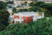 a red and white house surrounded by trees