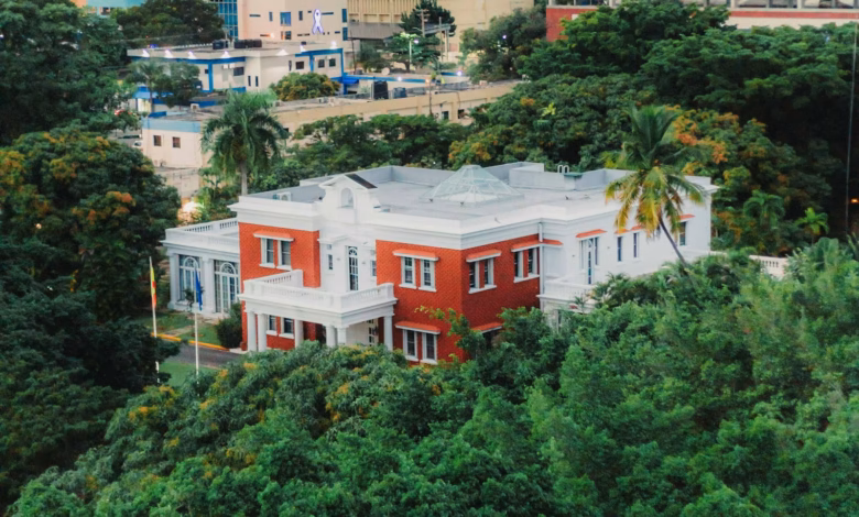 a red and white house surrounded by trees
