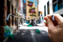 person holding eyeglasses