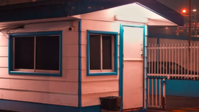A security guard house stands guard at night