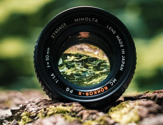 black Minolta lens in selective focus photography