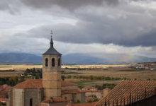 A view of a city with a rainbow in the sky