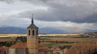A view of a city with a rainbow in the sky