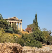 a building on top of a hill surrounded by trees