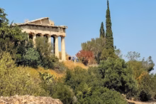 a building on top of a hill surrounded by trees