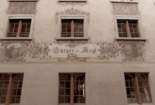 a building with windows and a sign on the side of it