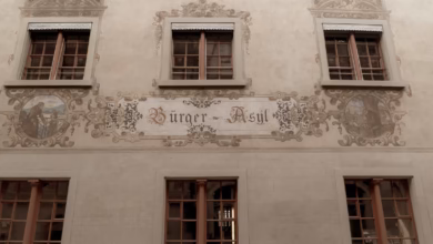 a building with windows and a sign on the side of it