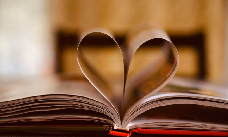 opened book on brown wooden table